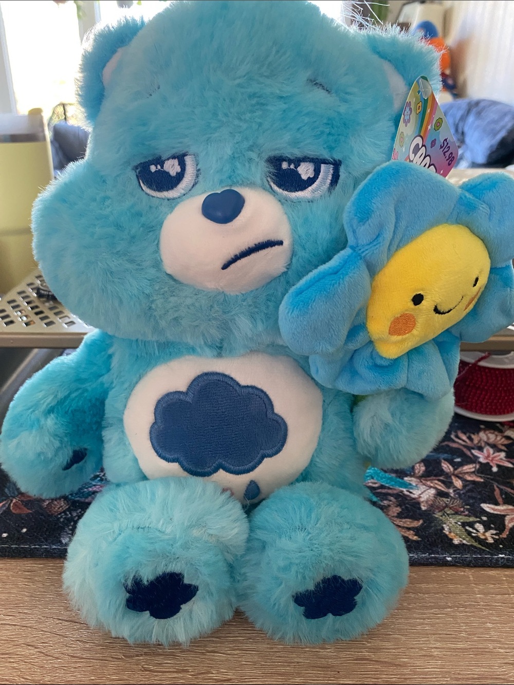 Care Bears. Grumpy Bear with a smiling sun flower.